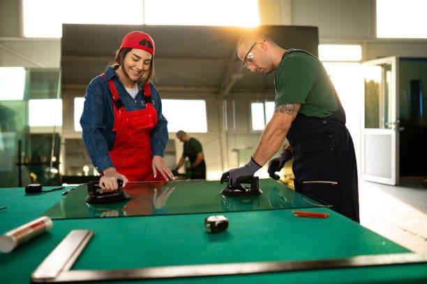 Two men collaborating on a glass table, engaged in a focused discussion or project work | Framing service in Newport Beach, CA.